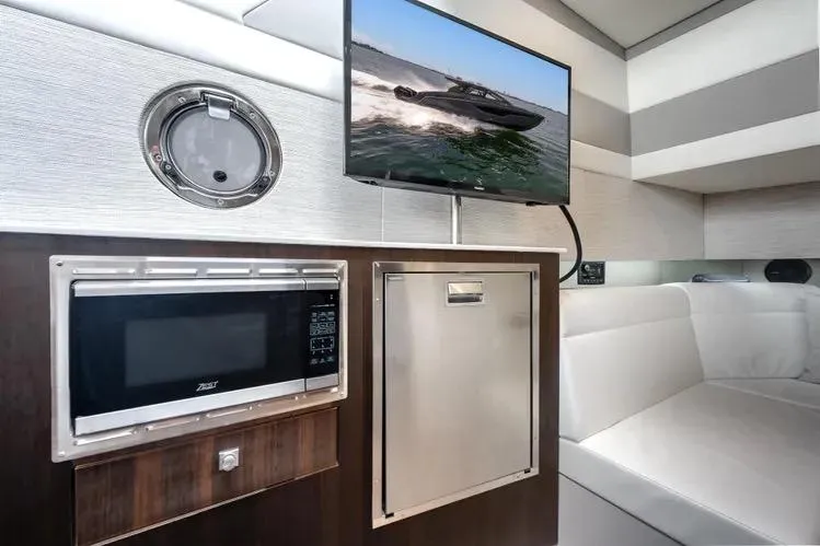  Yacht Photos Pics 2023 Cruisers 42 GLS OB interior with microwave, TV, and seating area.