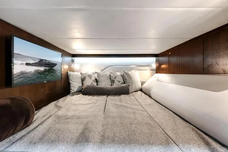  Yacht Photos Pics Luxurious cabin interior of 2023 Cruisers 42 GLS OB yacht with cozy bedding and TV.