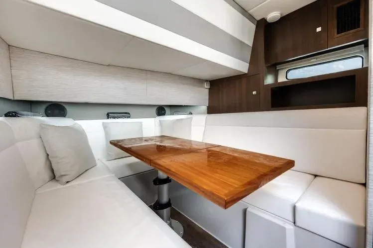  Yacht Photos Pics Luxurious interior of 2023 Cruisers 42 GLS OB yacht with elegant seating and wooden table.