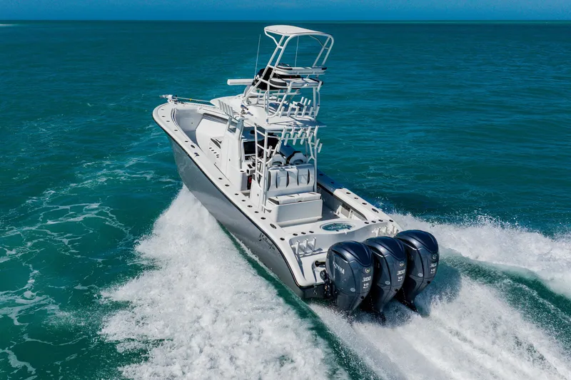  Yacht Photos Pics 2025 Yellowfin 36 Offshore boat cruising on open ocean with triple outboard engines.