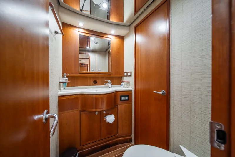 Jobsite Yacht Photos Pics Luxurious bathroom in a 2009 Bertram 630 yacht with wooden cabinetry and modern fixtures.