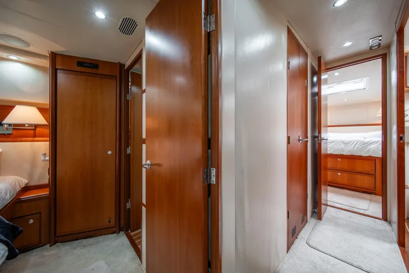 Jobsite Yacht Photos Pics Interior of 2009 Bertram 630 yacht with wooden doors and cozy bedroom.