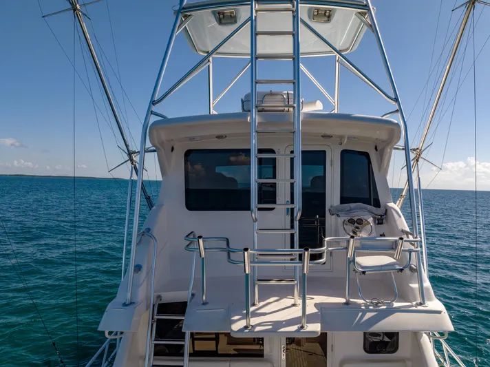 Jobsite Yacht Photos Pics Bertram 630 yacht, 2009 model, on open sea with clear blue sky.