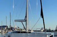 2022 Solaris 64 RS yacht docked in a marina under clear blue skies.