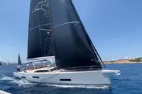 Sailing yacht Solaris 64 RS 2022 gliding on blue ocean waters under clear skies.
