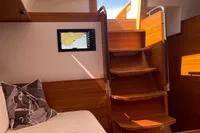 Luxurious interior of 2022 Solaris 64 RS yacht with wooden stairs and navigation screen.