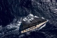 Aerial view of 2022 Solaris 64 RS yacht sailing on deep blue ocean waters.