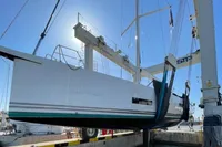 2022 Solaris 64 RS yacht being lifted by crane at a marina.