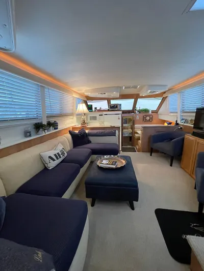 Lady Grace Yacht Photos Pics Luxurious interior of a 1995 Hatteras 52 Motor Yacht with elegant seating and decor.
