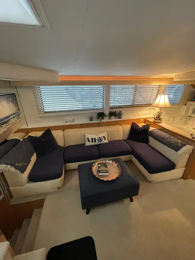 Lady Grace Yacht Photos Pics Luxurious interior of a 1995 Hatteras 52 Motor Yacht with cozy seating and elegant decor.