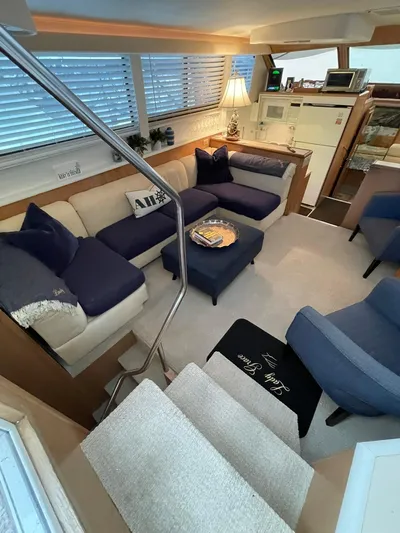 Lady Grace Yacht Photos Pics Luxurious interior of a 1995 Hatteras 52 Motor Yacht with cozy seating and elegant decor.