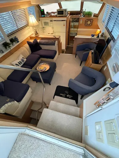 Lady Grace Yacht Photos Pics Luxurious interior of a 1995 Hatteras 52 Motor Yacht with cozy seating and elegant decor.