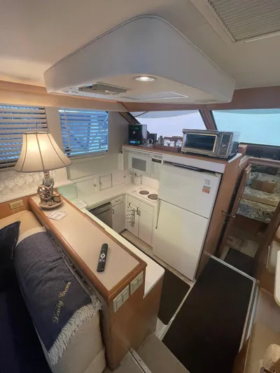 Lady Grace Yacht Photos Pics Interior of 1995 Hatteras 52 Motor Yacht with kitchen and cozy seating area.