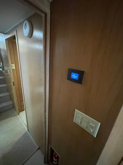 Lady Grace Yacht Photos Pics Interior of 1995 Hatteras 52 Motor Yacht with wooden paneling and control panel.