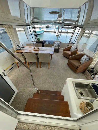 Lady Grace Yacht Photos Pics Luxurious interior of a 1995 Hatteras 52 Motor Yacht with elegant seating and dining area.