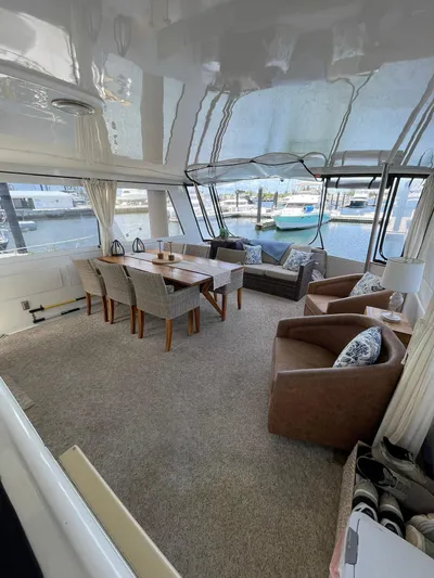 Lady Grace Yacht Photos Pics Luxurious interior of 1995 Hatteras 52 Motor Yacht with elegant seating and dining area.