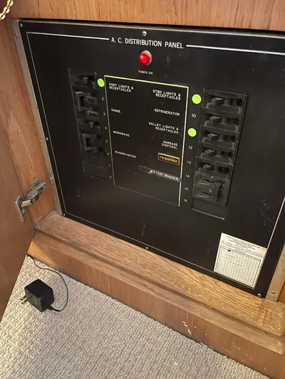 Lady Grace Yacht Photos Pics A.C. distribution panel on 1995 Hatteras 52 Motor Yacht, showing circuit breakers and controls.