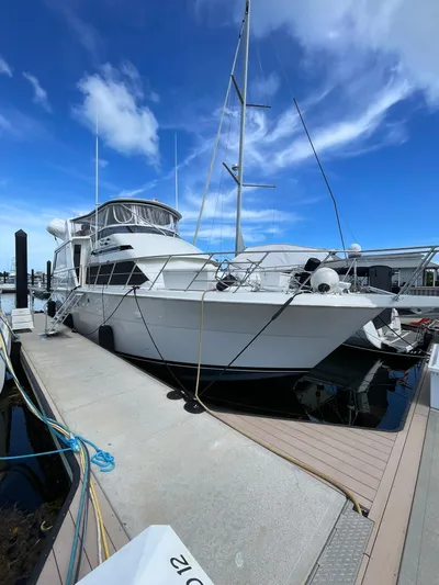 Lady Grace Yacht Photos Pics 1995 Hatteras 52 Motor Yacht docked under a clear blue sky.
