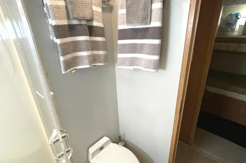 Lady Grace Yacht Photos Pics Bathroom interior of 1995 Hatteras 52 Motor Yacht with striped towels and shower.