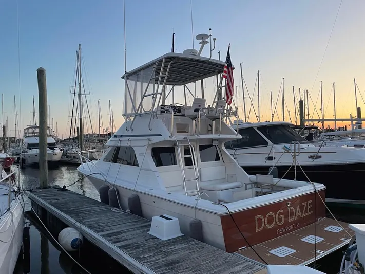 Dog Daze Yacht Photos Pics 2001 Jupiter 35 Convertible yacht docked at sunset, featuring "Dog Daze" nameplate.