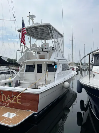 Dog Daze Yacht Photos Pics 2001 Jupiter 35 Convertible yacht docked, featuring flybridge and American flag.