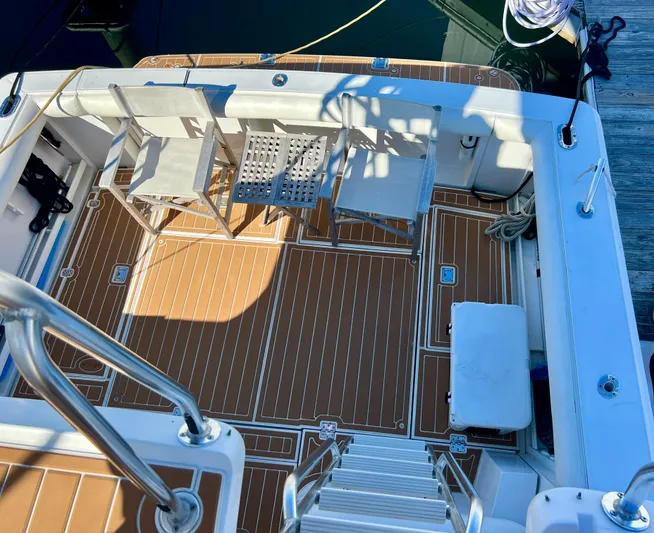 Dog Daze Yacht Photos Pics Deck of 2001 Jupiter 35 Convertible boat with seating and wooden flooring.