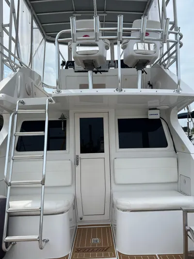 Dog Daze Yacht Photos Pics 2001 Jupiter 35 Convertible boat interior with ladder and seating area.