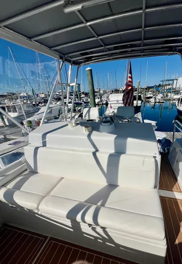 Dog Daze Yacht Photos Pics 2001 Jupiter 35 Convertible boat interior with white seating, docked at a marina.