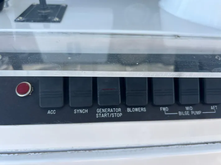 Dog Daze Yacht Photos Pics Control panel of a 2001 Jupiter 35 Convertible boat with labeled switches.