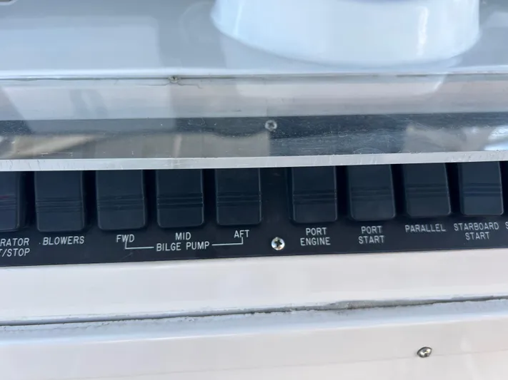 Dog Daze Yacht Photos Pics Control panel of a 2001 Jupiter 35 Convertible boat with labeled switches.