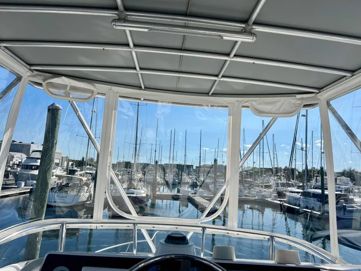 Dog Daze Yacht Photos Pics View from 2001 Jupiter 35 Convertible boat, overlooking marina with sailboats and clear sky.