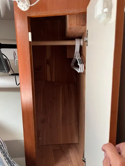 Dog Daze Yacht Photos Pics Wooden closet interior with hangers in a 2001 Jupiter 35 Convertible boat.