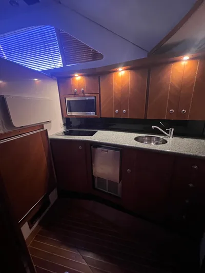 Dog Daze Yacht Photos Pics Luxurious kitchen interior of 2001 Jupiter 35 Convertible yacht with modern amenities.