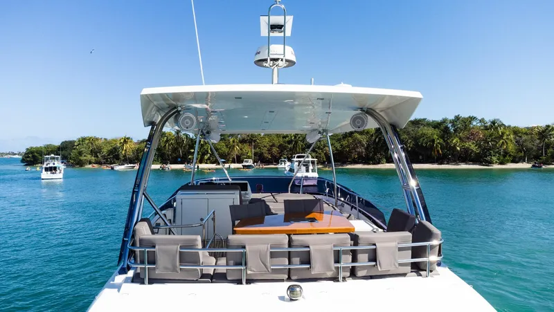  Yacht Photos Pics Prestige 560 Flybridge 2018 yacht on serene blue water with lush green shoreline.