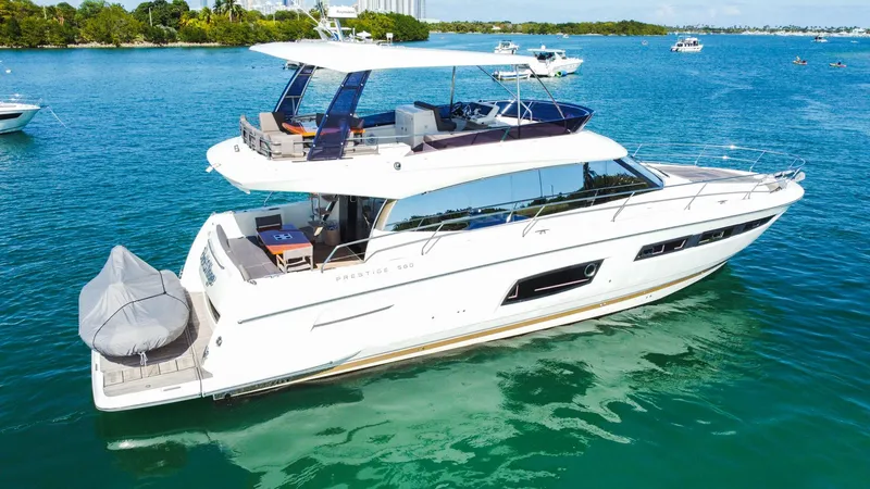  Yacht Photos Pics 2018 Prestige 560 Flybridge yacht cruising on clear blue water.