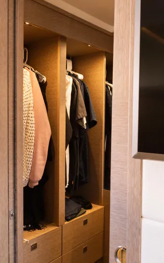  Yacht Photos Pics Closet interior on 2018 Prestige 560 Flybridge yacht with hanging clothes and drawers.