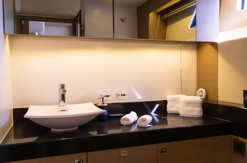  Yacht Photos Pics Luxurious bathroom in 2018 Prestige 560 Flybridge yacht with modern sink and elegant lighting.