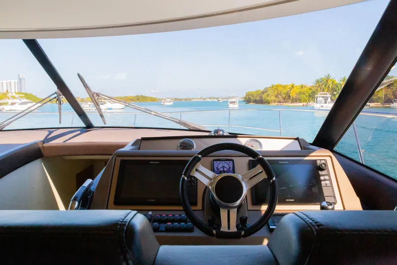  Yacht Photos Pics Prestige 560 Flybridge 2018 yacht helm with scenic waterway view.