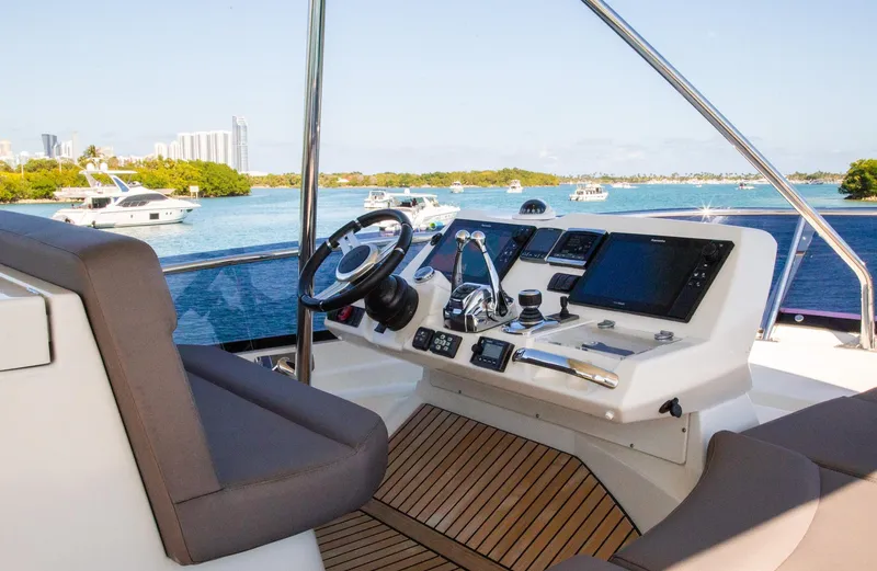  Yacht Photos Pics Flybridge helm of 2018 Prestige 560 yacht with scenic waterfront view.