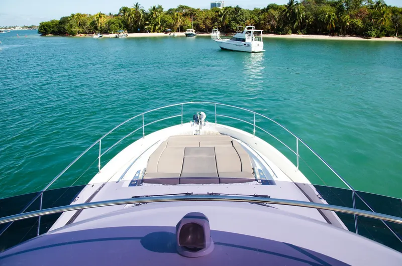  Yacht Photos Pics Prestige 560 Flybridge 2018 yacht cruising near tropical island with clear blue water.