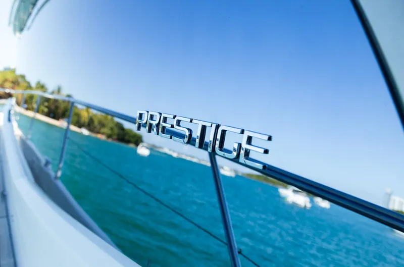  Yacht Photos Pics Prestige 560 Flybridge yacht, 2018 model, cruising on clear blue waters.