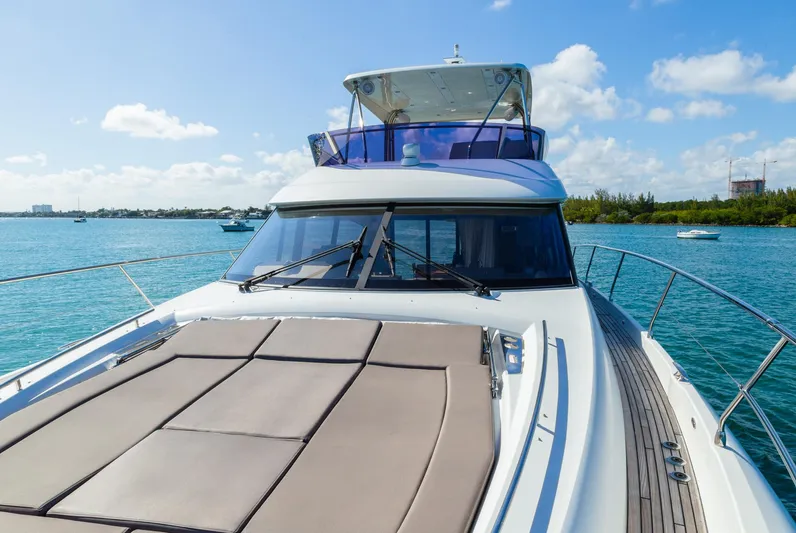  Yacht Photos Pics 2018 Prestige 560 Flybridge yacht on serene blue waters under a clear sky.
