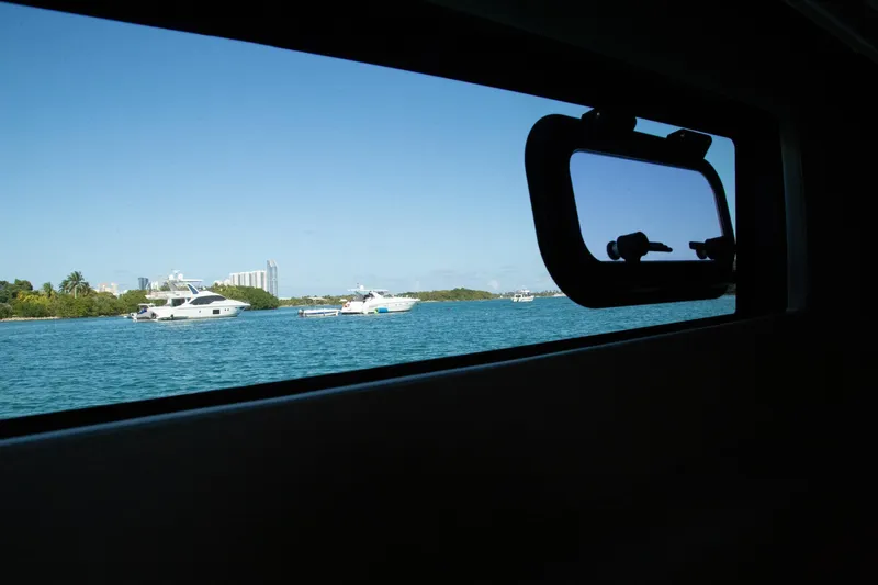  Yacht Photos Pics View from Prestige 560 Flybridge 2018 yacht window, overlooking boats on a sunny day.