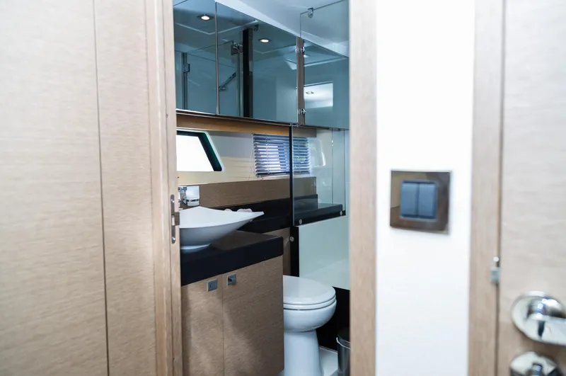  Yacht Photos Pics Luxurious bathroom interior of 2018 Prestige 560 Flybridge yacht with modern fixtures.