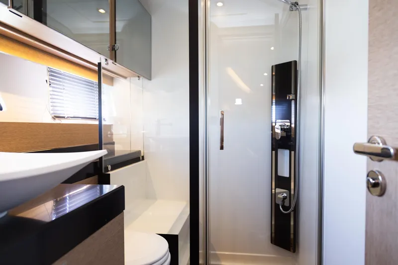 Yacht Photos Pics Luxurious bathroom in 2018 Prestige 560 Flybridge yacht with modern shower and sleek design.