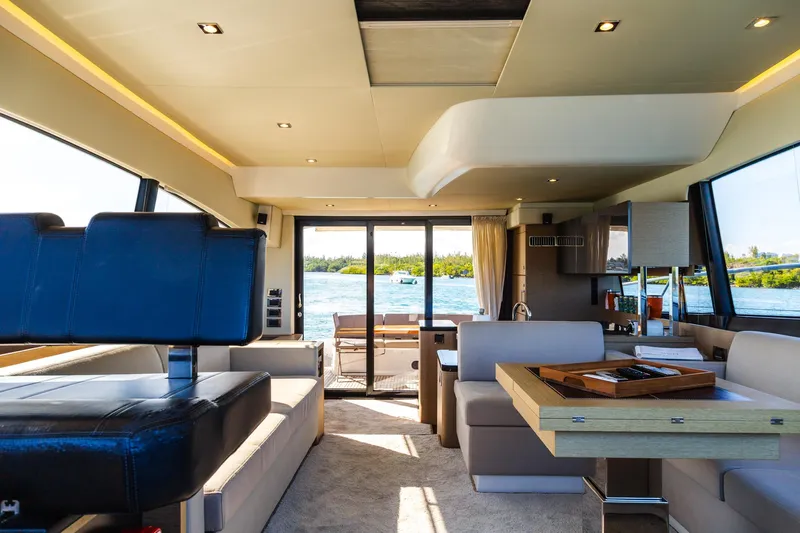  Yacht Photos Pics Luxurious interior of a 2018 Prestige 560 Flybridge yacht with modern furnishings and scenic water view.