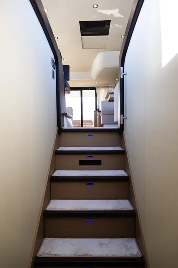  Yacht Photos Pics Staircase inside 2018 Prestige 560 Flybridge yacht, leading to upper deck with modern interior.