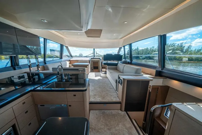  Yacht Photos Pics Luxurious interior of 2018 Prestige 560 Flybridge yacht with modern kitchen and seating area.