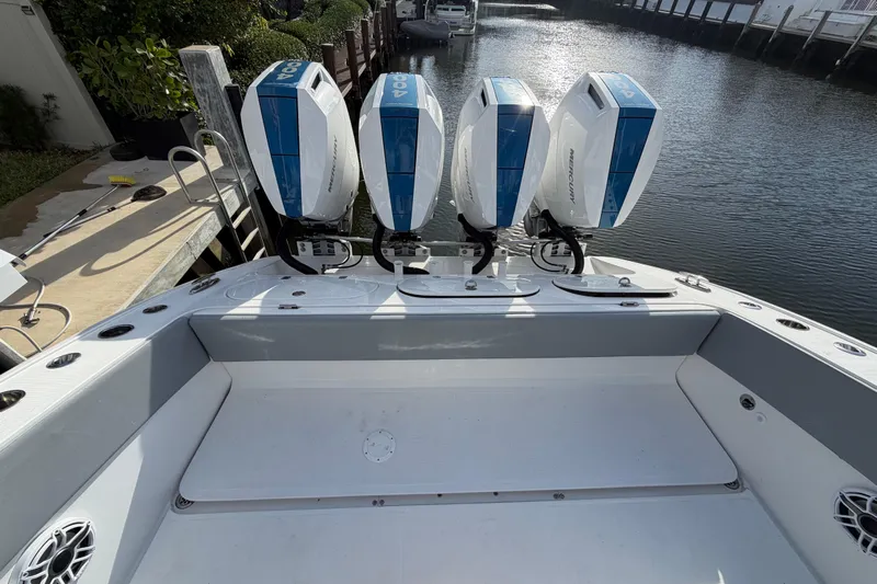  Yacht Photos Pics Midnight Express 43 Open boat with four powerful Mercury outboard engines docked by the water.