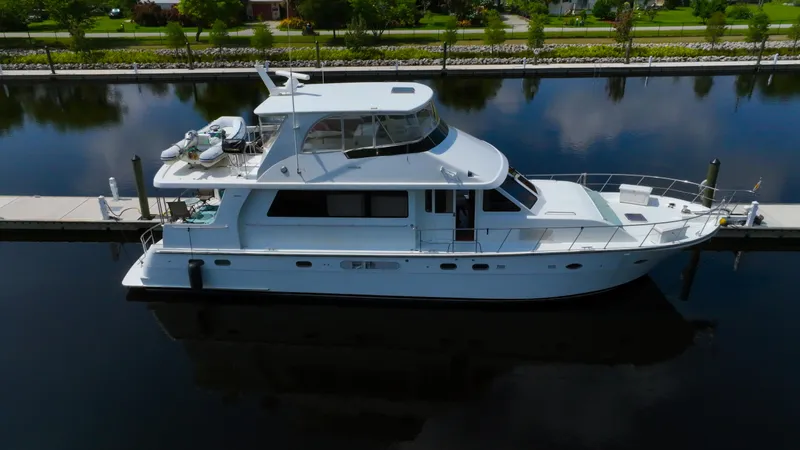 Instead Of Yacht Photos Pics 2005 Jefferson Marquessa 60 MY yacht docked in calm waters, side view.